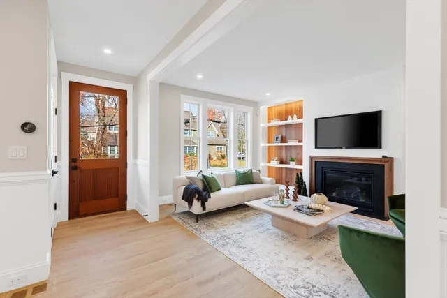 a living room with furniture flat screen tv and a fireplace