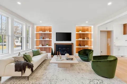 a living room with furniture fireplace and a flat screen tv