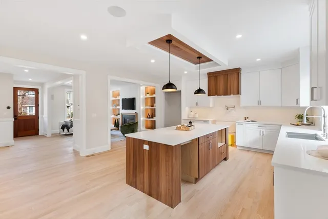 a kitchen with stainless steel appliances kitchen island a sink stove and cabinets