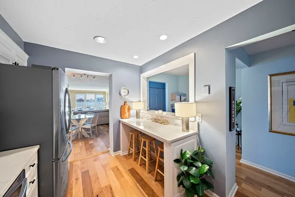 a kitchen with stainless steel appliances kitchen island granite countertop a sink stove and refrigerator