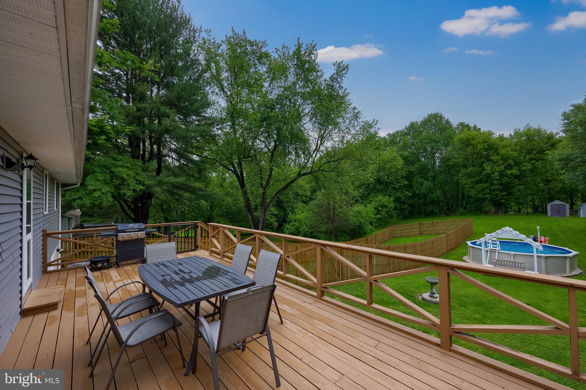 699 River Corner Road Conestoga, PA 17516 - Photo 24 of 37 a view of a roof deck with table and chairs with wooden floor and fence