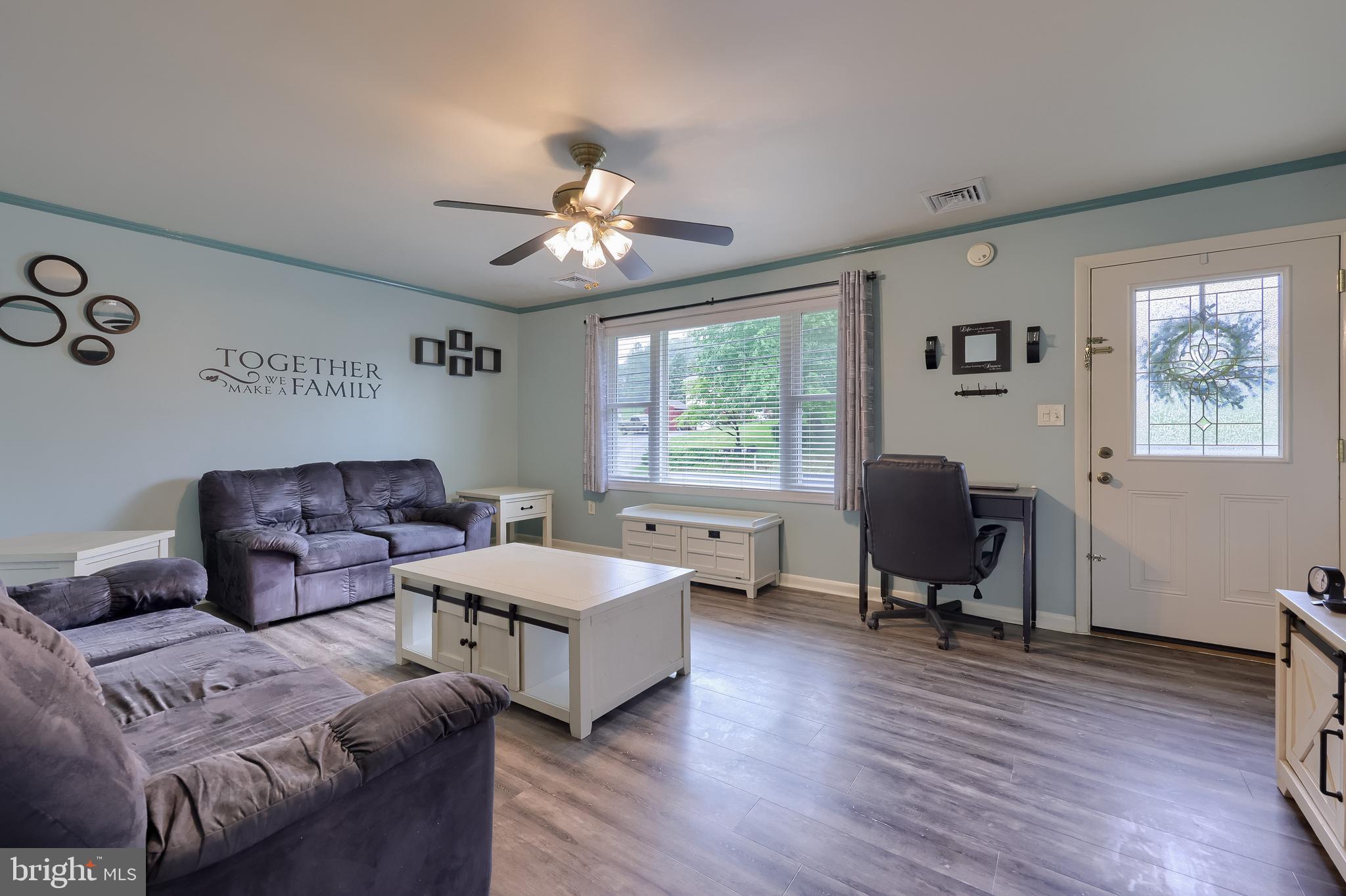 699 River Corner Road Conestoga, PA 17516 - Photo 5 of 37 a living room with furniture two window and wooden floor