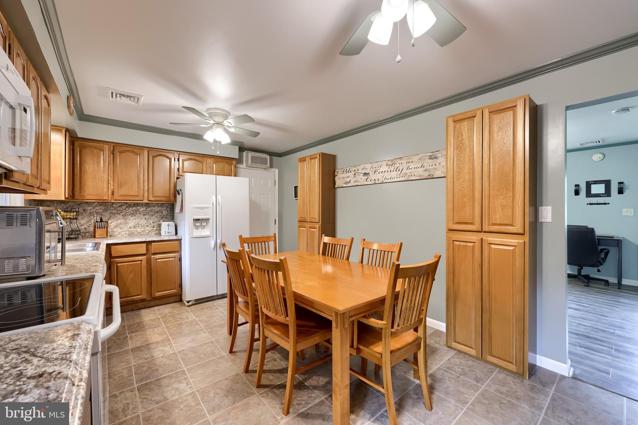699 River Corner Road Conestoga, PA 17516 - Photo 9 of 37 a dining area with furniture a kitchen and chandelier