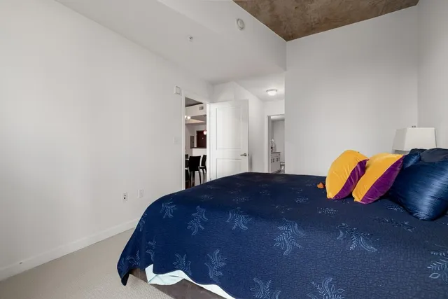 a bathroom with a granite countertop sink a toilet and a shower