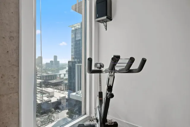 a bathroom with a granite countertop sink a toilet a mirror and bathtub