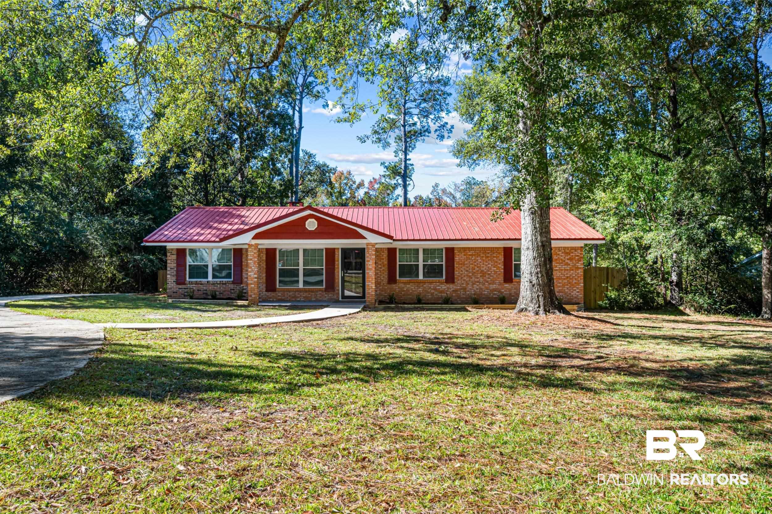 1605 Collier Avenue Bay Minette, AL 36507 - Photo 1 of 36 Ranch-style house featuring a metal roof, brick siding, and a porch