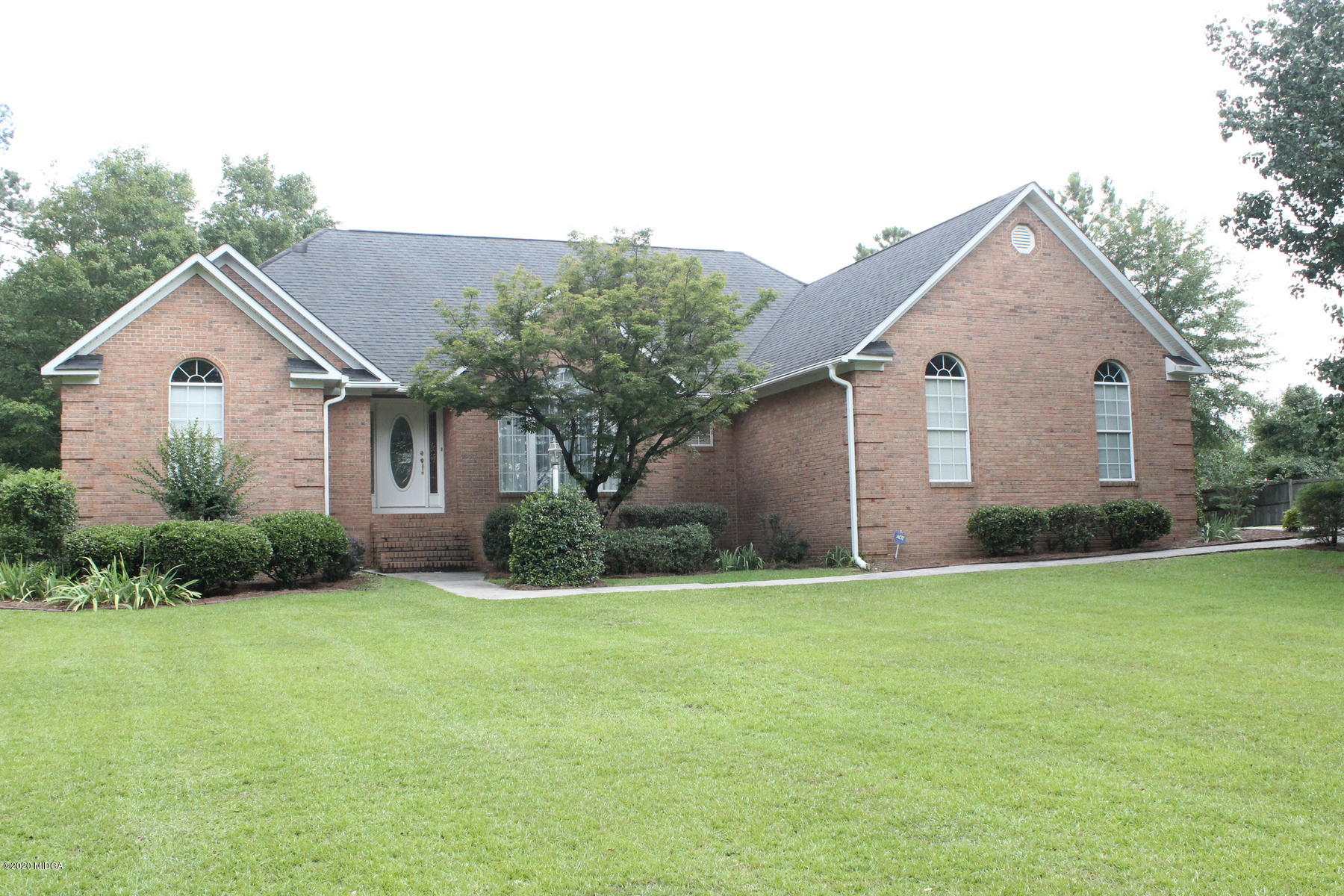 144 Gates Road Lizella, GA 31052 - Photo 1 of 44 a view of a yard in front of a house with plants and large tree