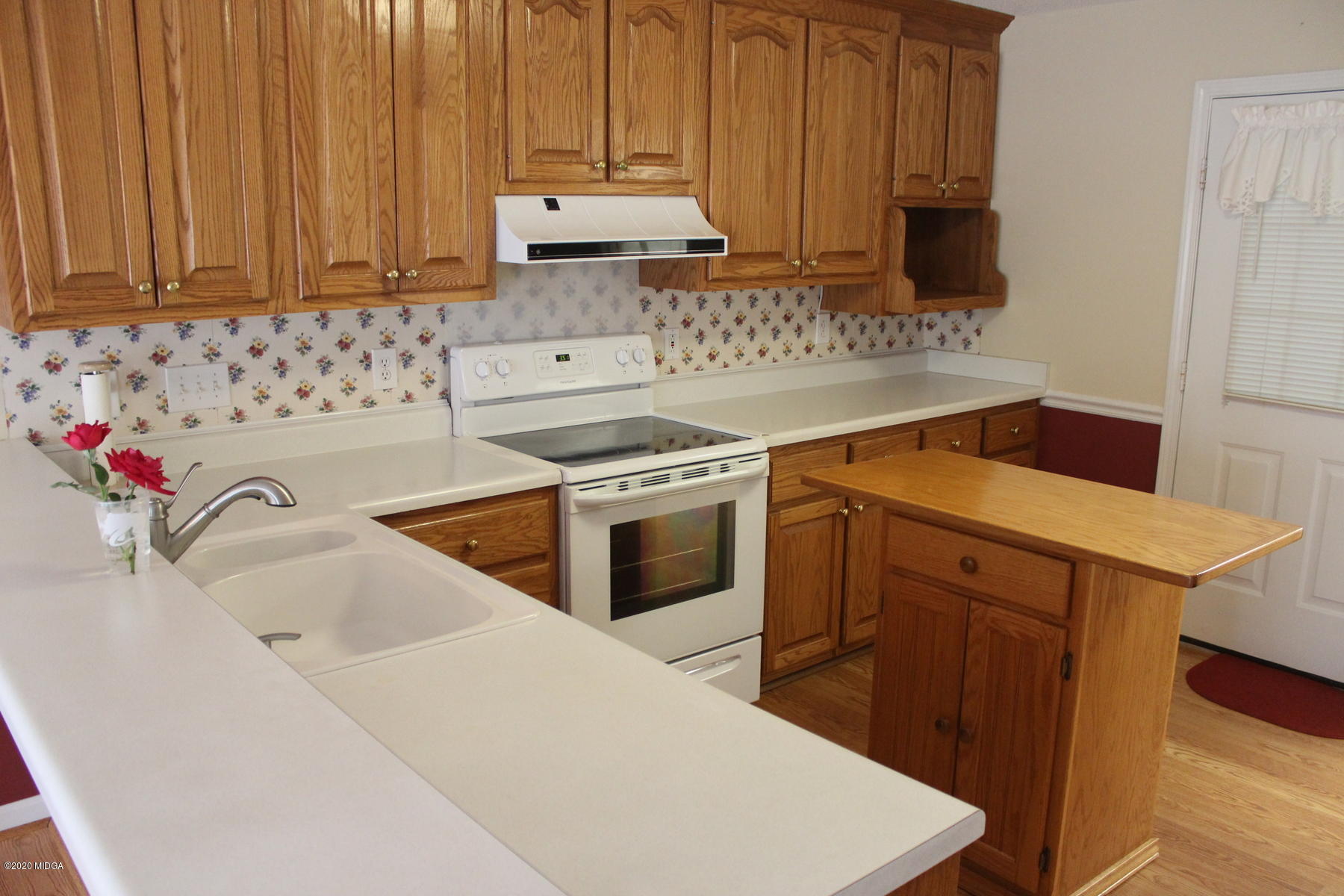 144 Gates Road Lizella, GA 31052 - Photo 11 of 44 a kitchen with a sink stove and cabinets