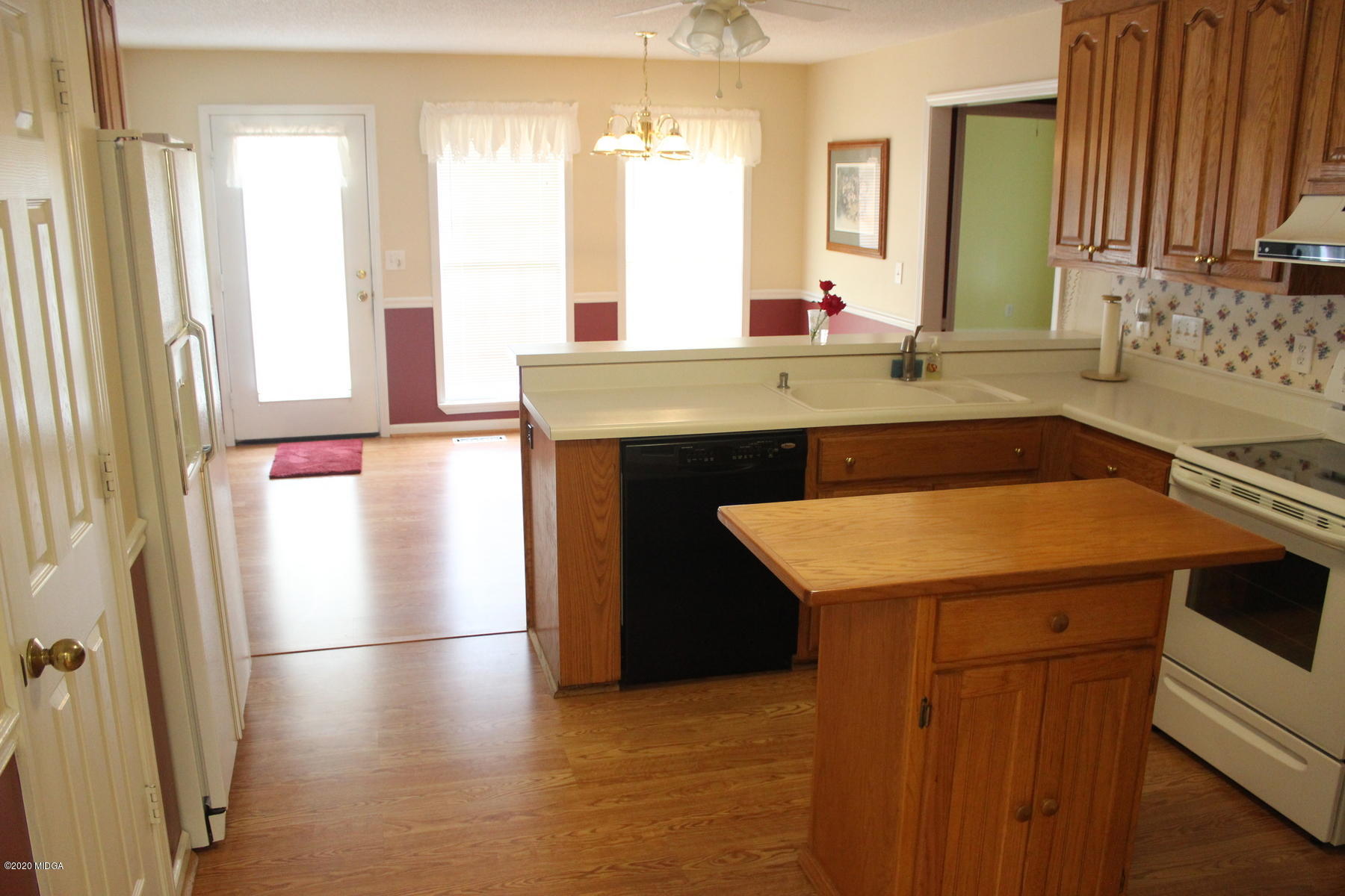 144 Gates Road Lizella, GA 31052 - Photo 13 of 44 a kitchen with a sink a stove and a refrigerator