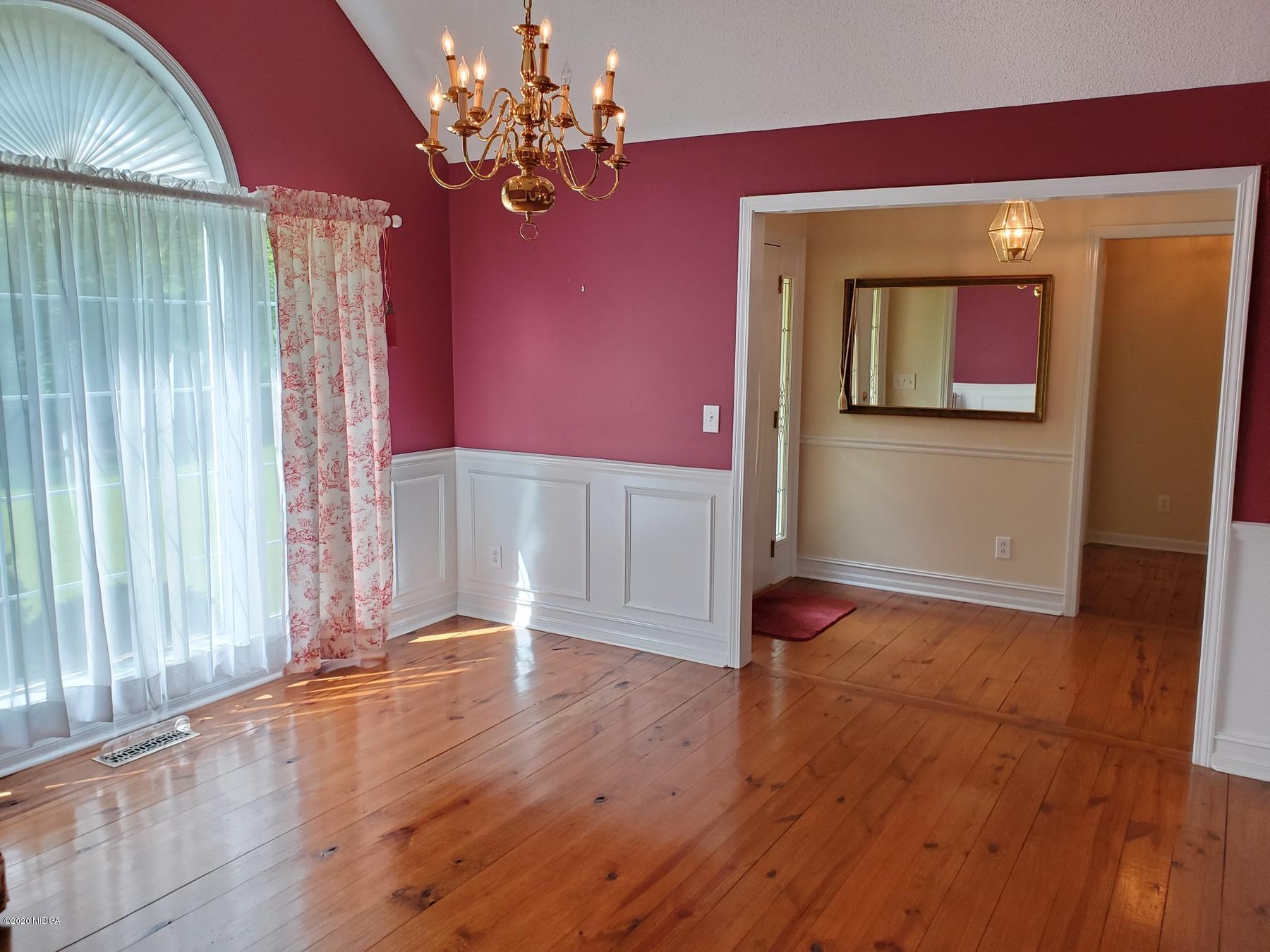 144 Gates Road Lizella, GA 31052 - Photo 17 of 44 a view of an empty room with a window and wooden floor