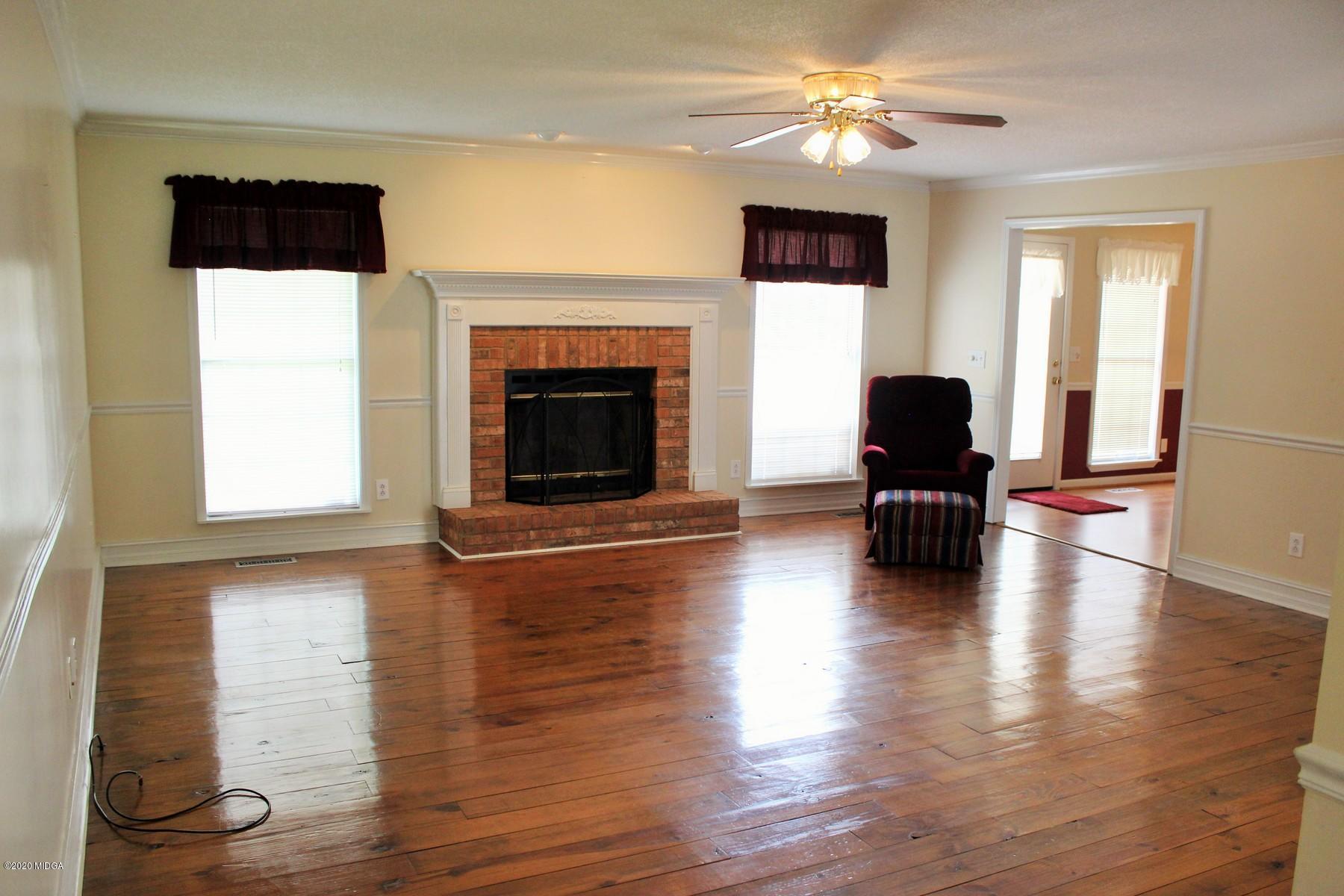 144 Gates Road Lizella, GA 31052 - Photo 20 of 44 a living room with furniture and a fireplace