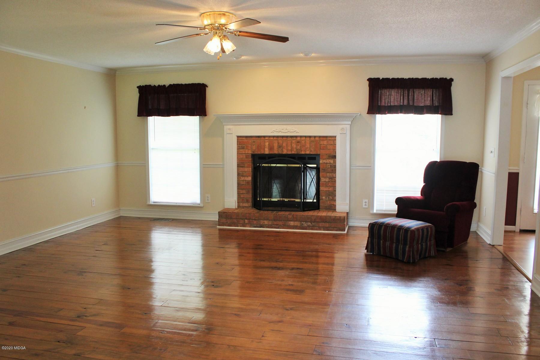 144 Gates Road Lizella, GA 31052 - Photo 21 of 44 a living room with furniture and a fireplace