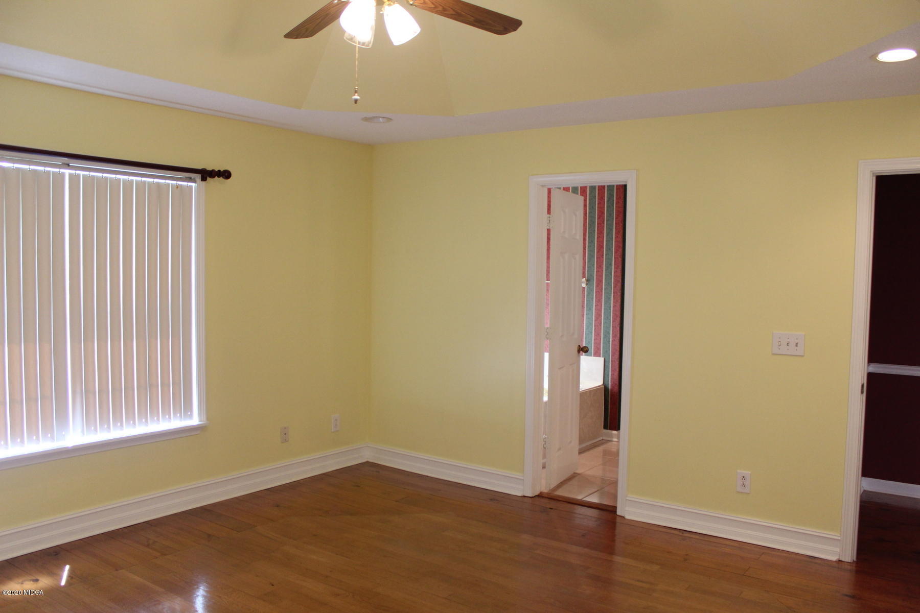 144 Gates Road Lizella, GA 31052 - Photo 27 of 44 an empty room with wooden floor and a ceiling fan
