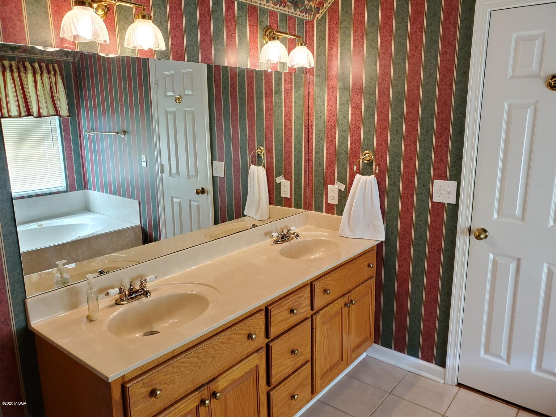 144 Gates Road Lizella, GA 31052 - Photo 29 of 44 a bathroom with a sink and a mirror