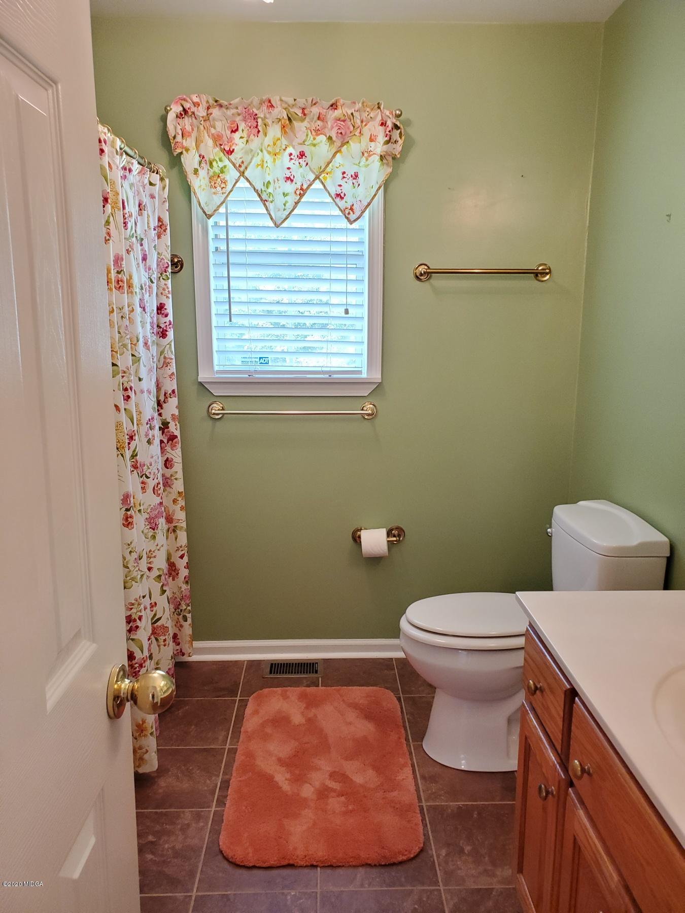 144 Gates Road Lizella, GA 31052 - Photo 36 of 44 a bathroom with a toilet and a window