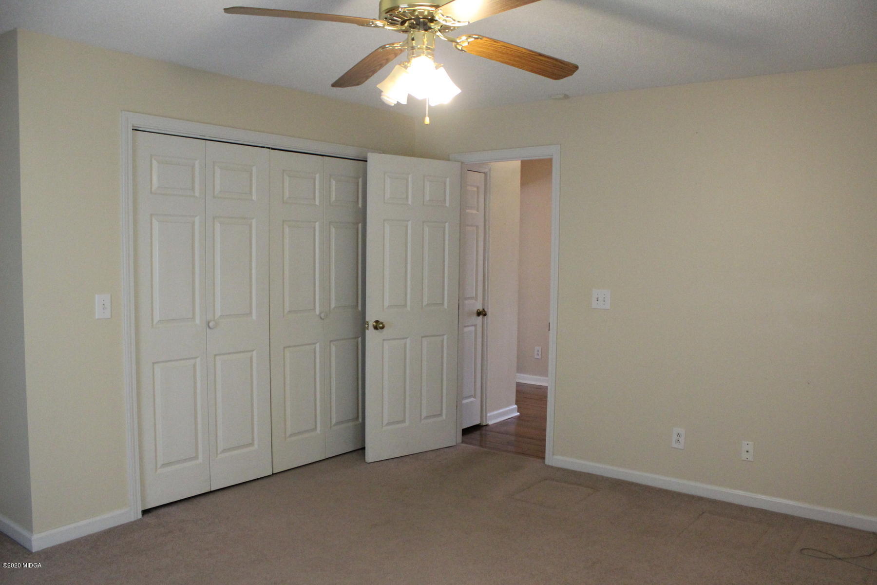 144 Gates Road Lizella, GA 31052 - Photo 39 of 44 an empty room with a ceiling fan and a window