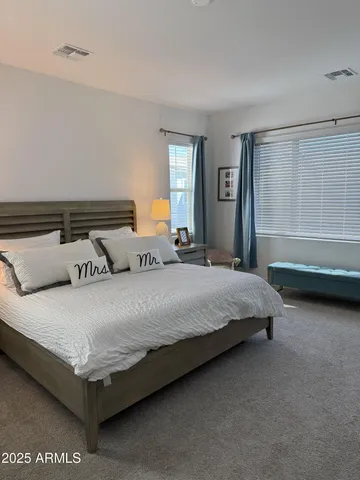 a bedroom with a bed and window