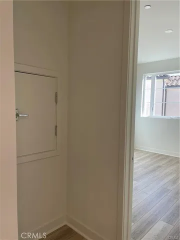 a view of a street with potted plants