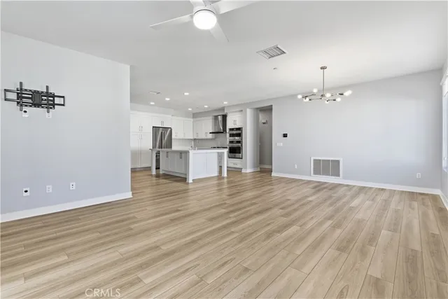 an empty room with wooden floor and a bathroom
