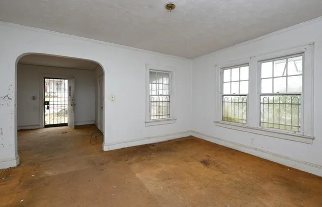 an empty room with a empty space and windows