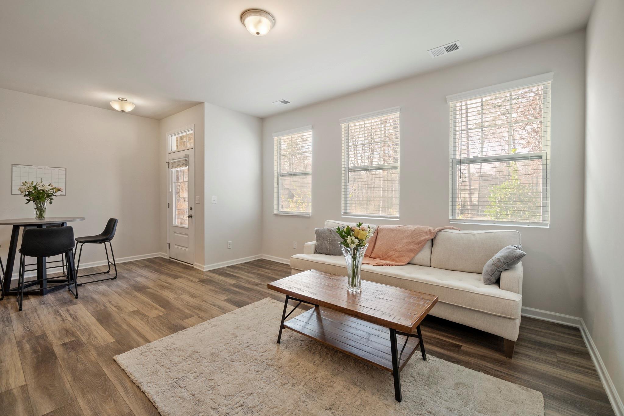 1564 Galloway Road Charlotte, NC 28262 - Photo 13 of 37 a living room with furniture and a potted plant next to a window