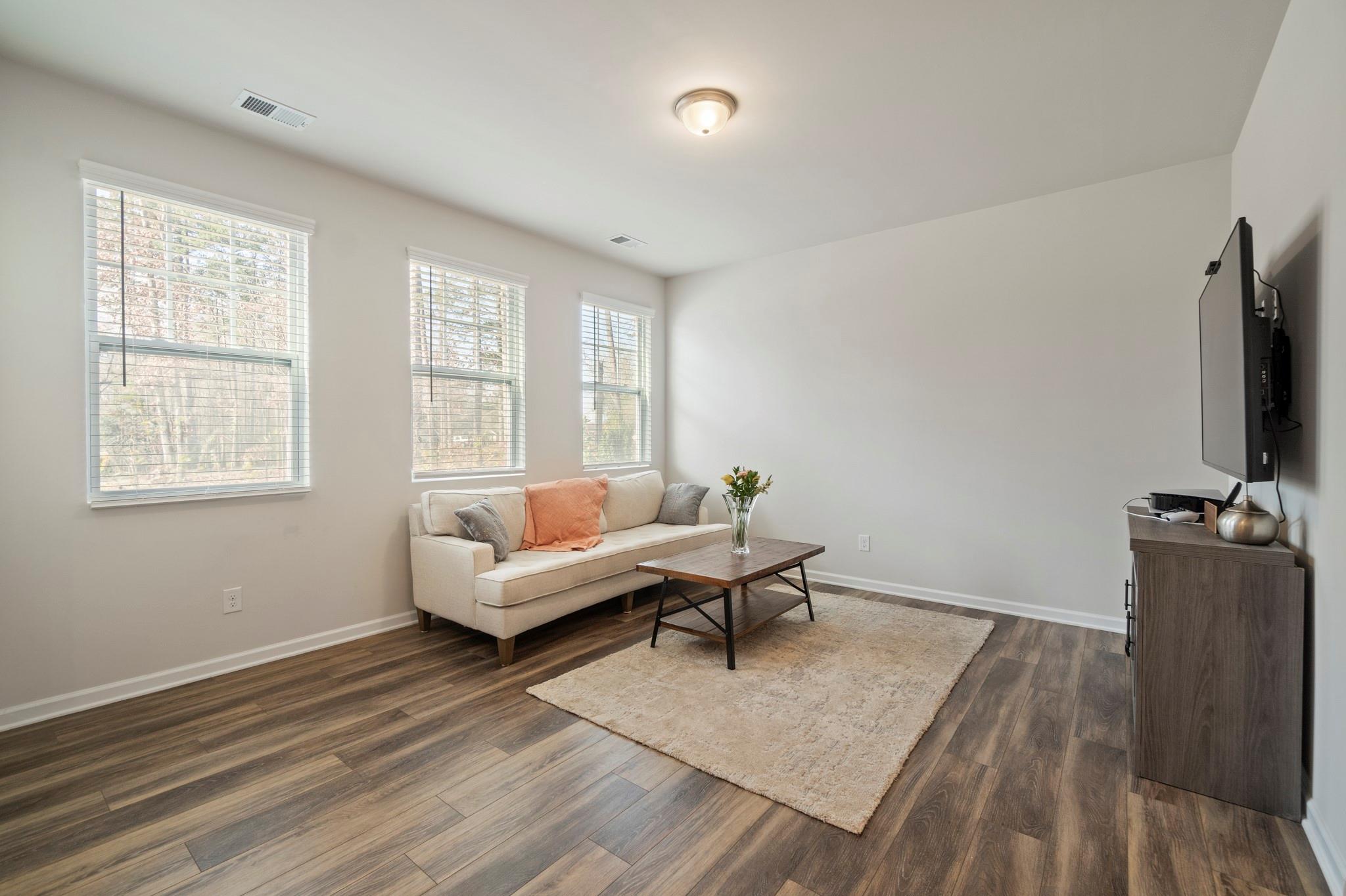 1564 Galloway Road Charlotte, NC 28262 - Photo 14 of 37 a living room with furniture and a flat screen tv
