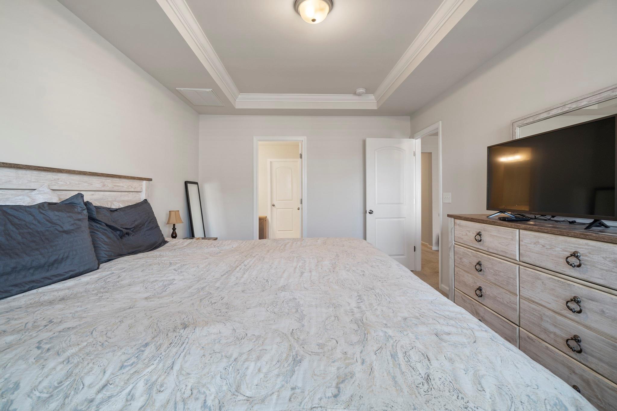 1564 Galloway Road Charlotte, NC 28262 - Photo 21 of 37 a bedroom with a bed and a flat screen tv