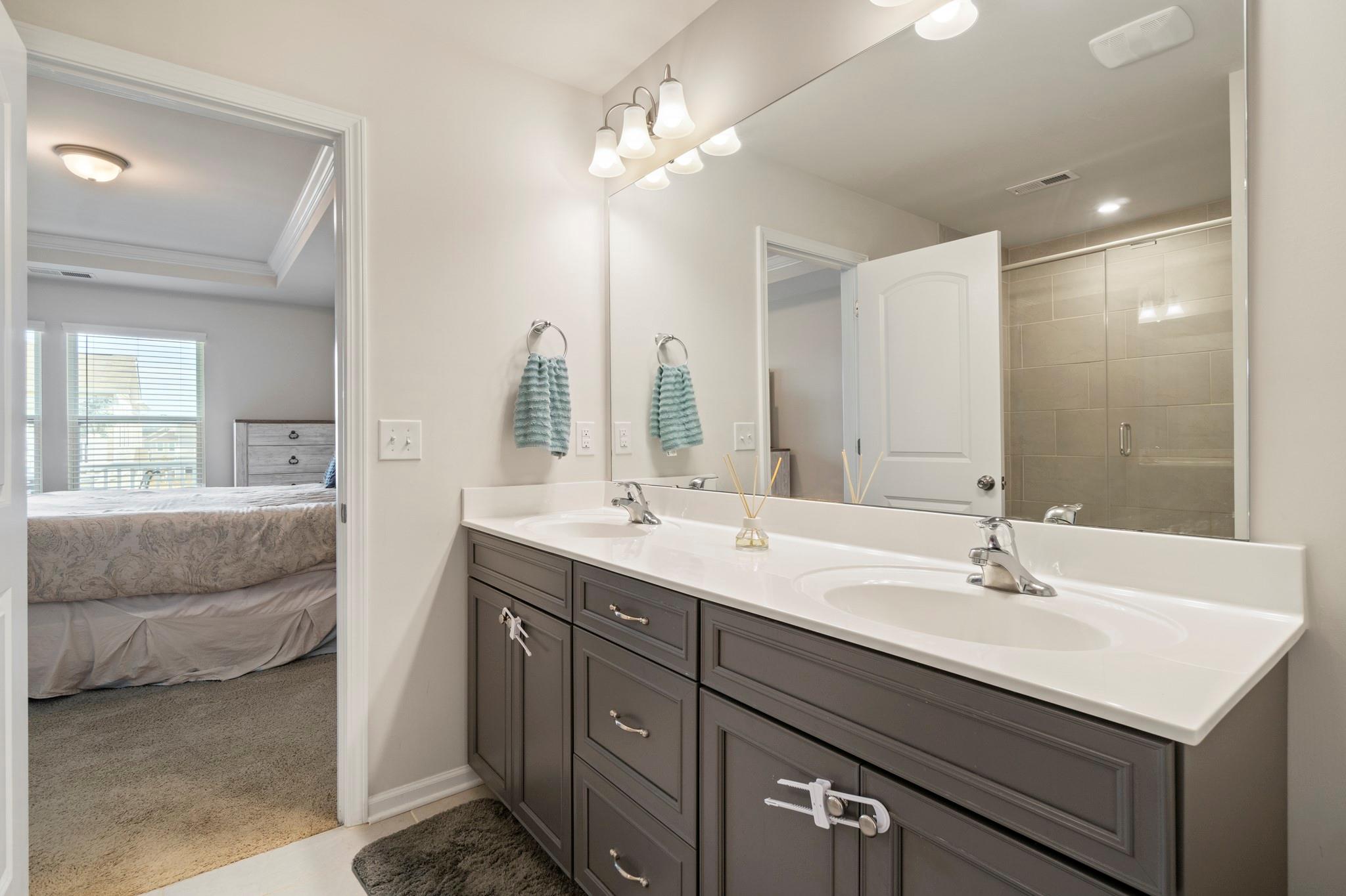 1564 Galloway Road Charlotte, NC 28262 - Photo 22 of 37 a bathroom with a sink double vanity and a mirror