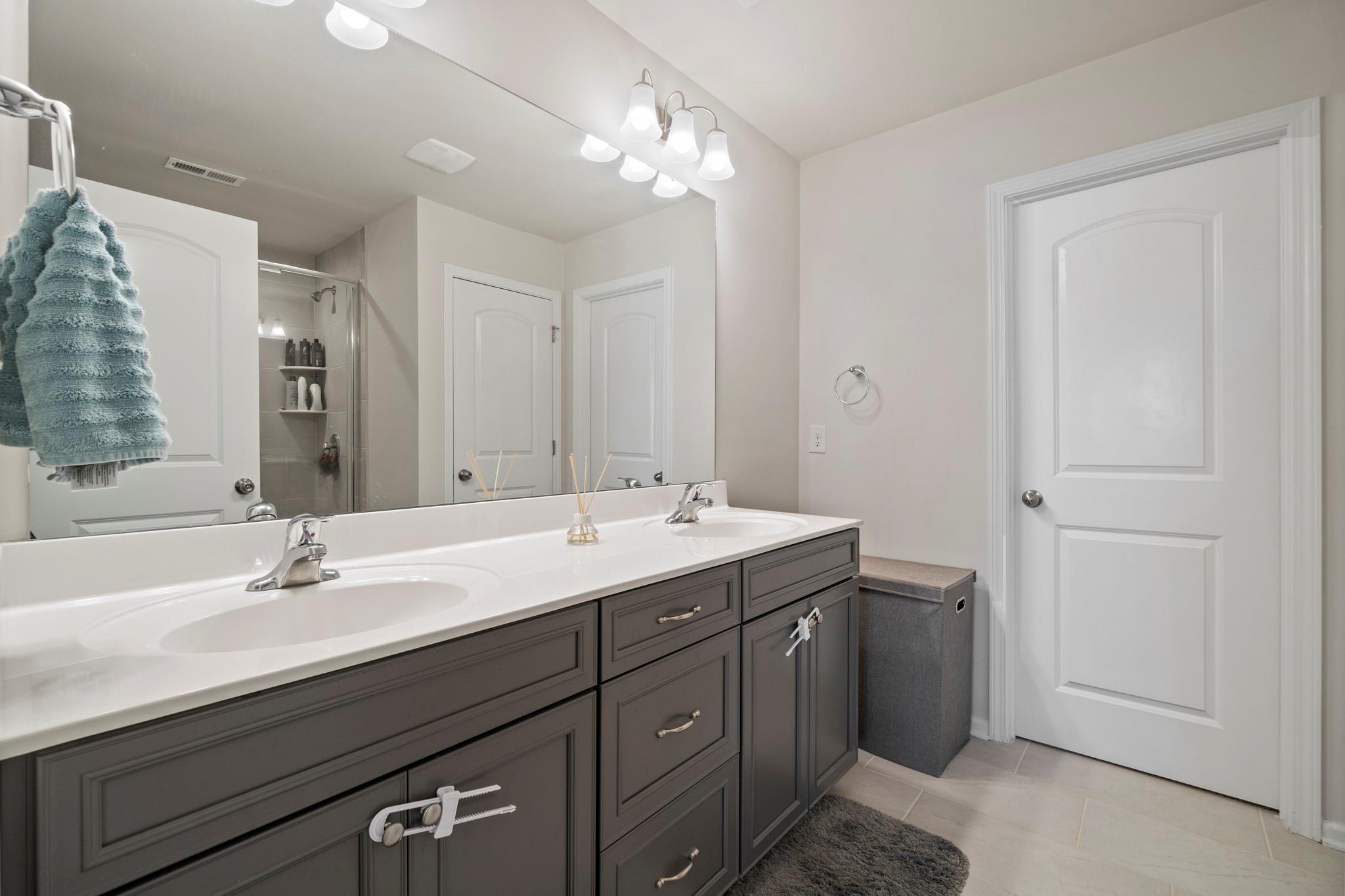 1564 Galloway Road Charlotte, NC 28262 - Photo 23 of 37 a bathroom with a sink double vanity and a mirror