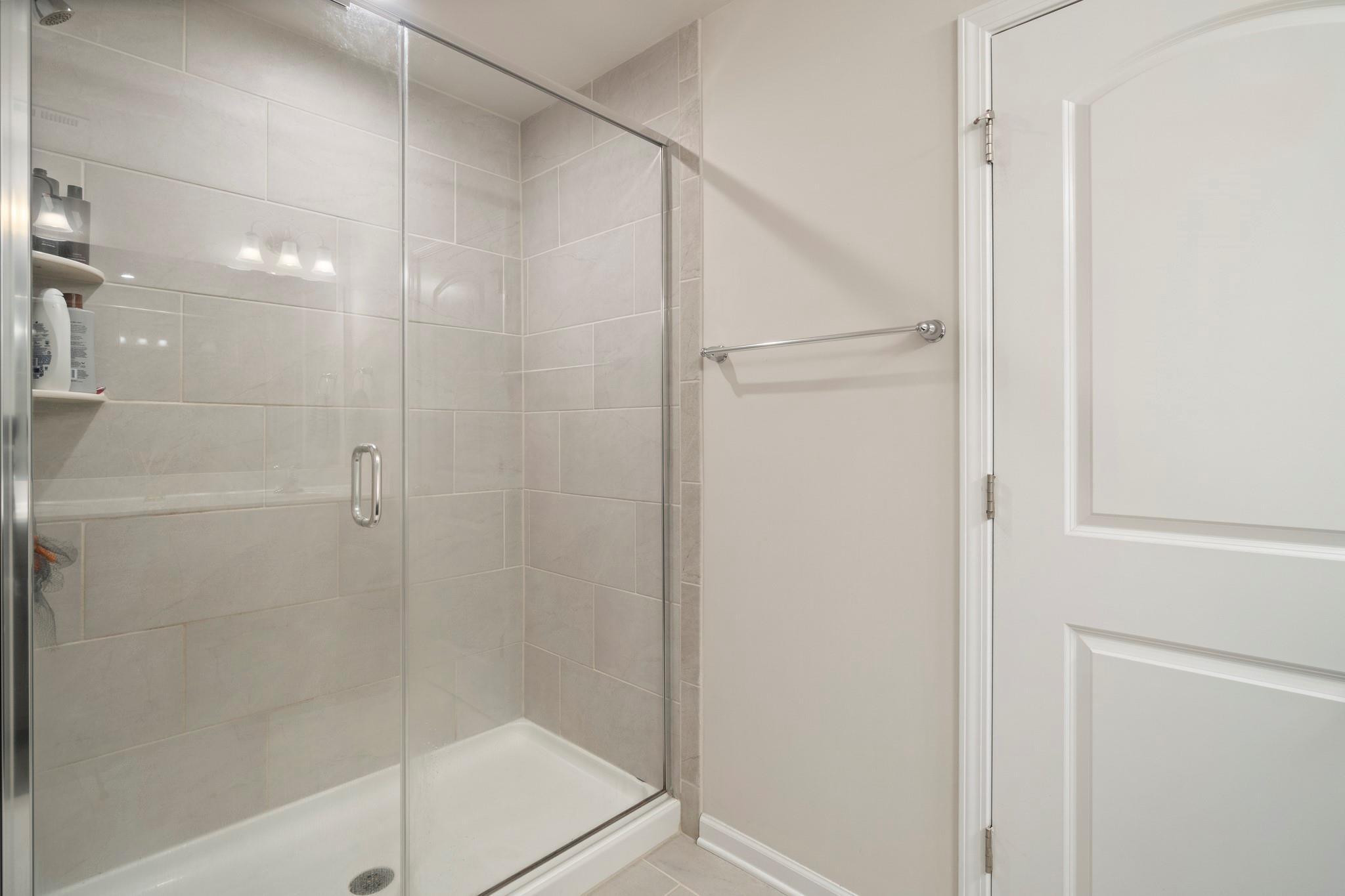 1564 Galloway Road Charlotte, NC 28262 - Photo 24 of 37 a bathroom with a glass shower door