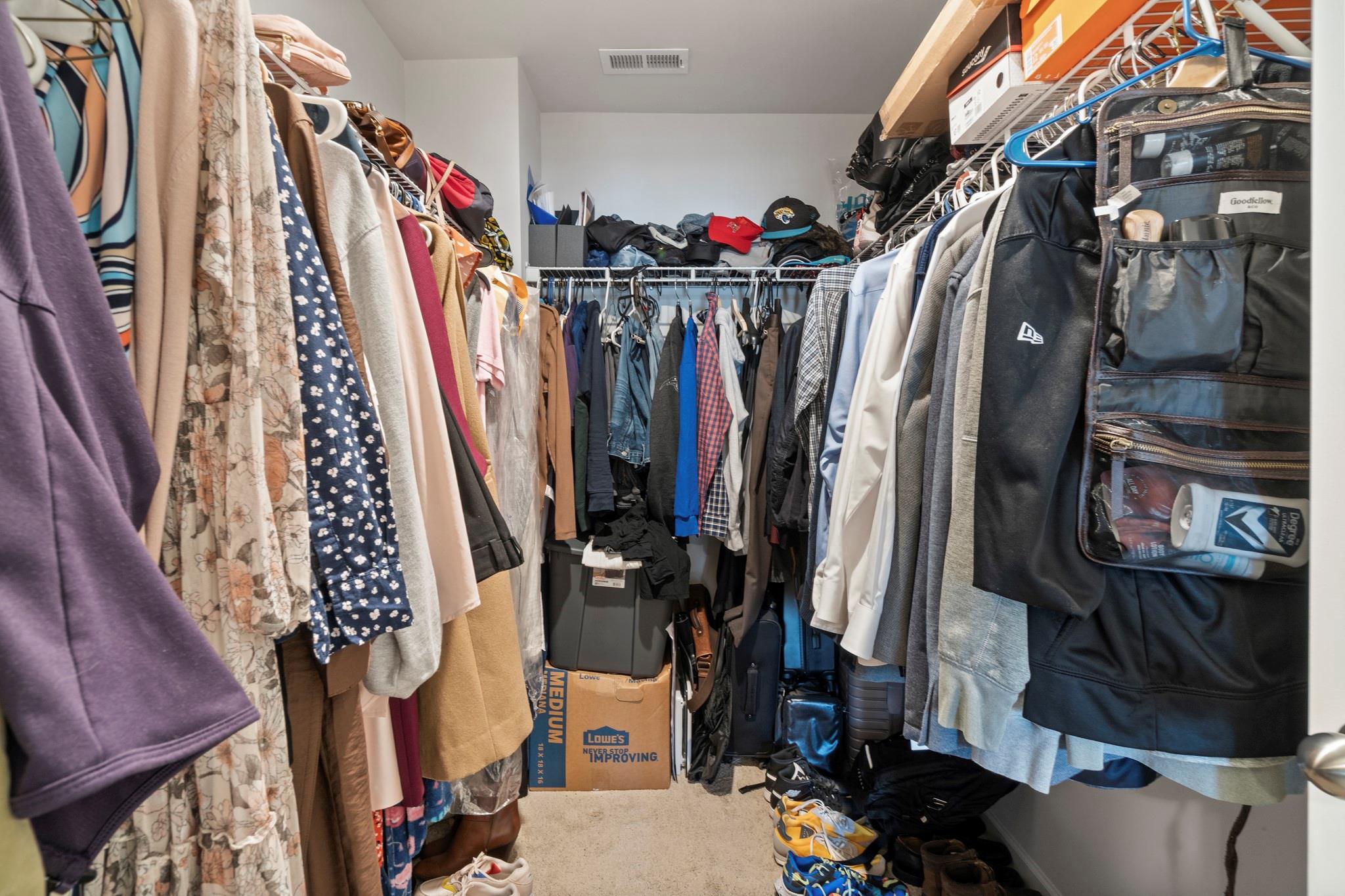 1564 Galloway Road Charlotte, NC 28262 - Photo 25 of 37 a view of walk in closet with clothes