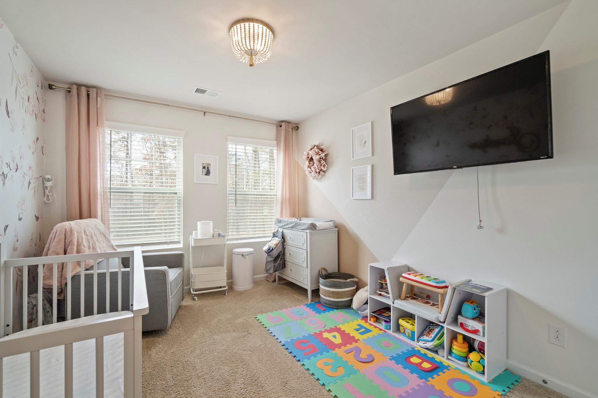 1564 Galloway Road Charlotte, NC 28262 - Photo 27 of 37 a bedroom with furniture and a flat screen tv