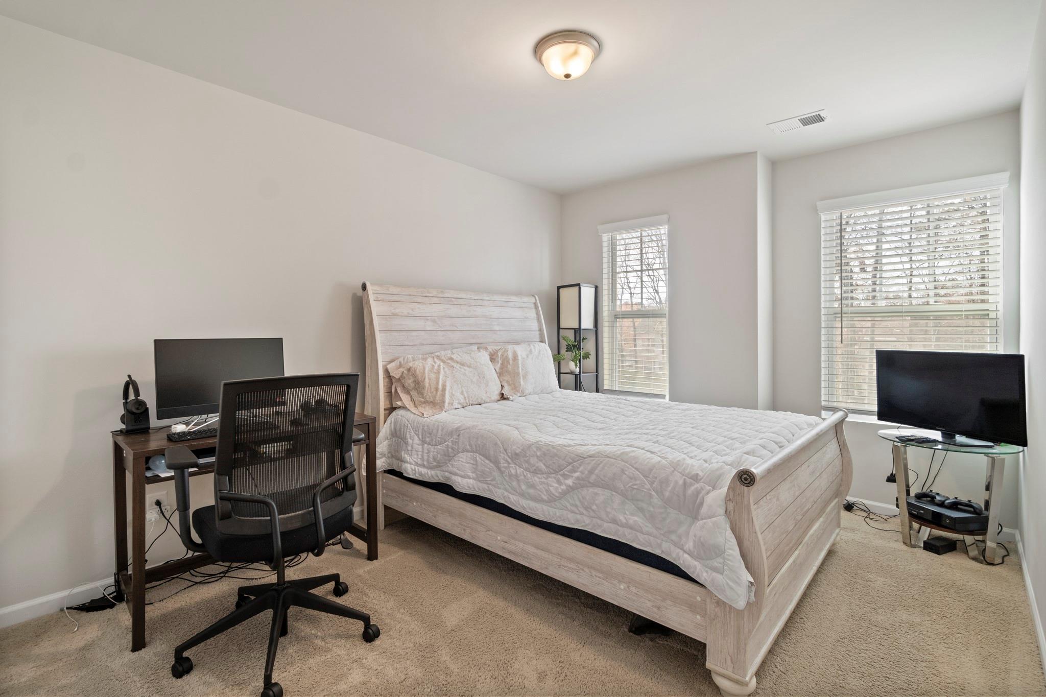 1564 Galloway Road Charlotte, NC 28262 - Photo 29 of 37 a bedroom with a bed and a desk