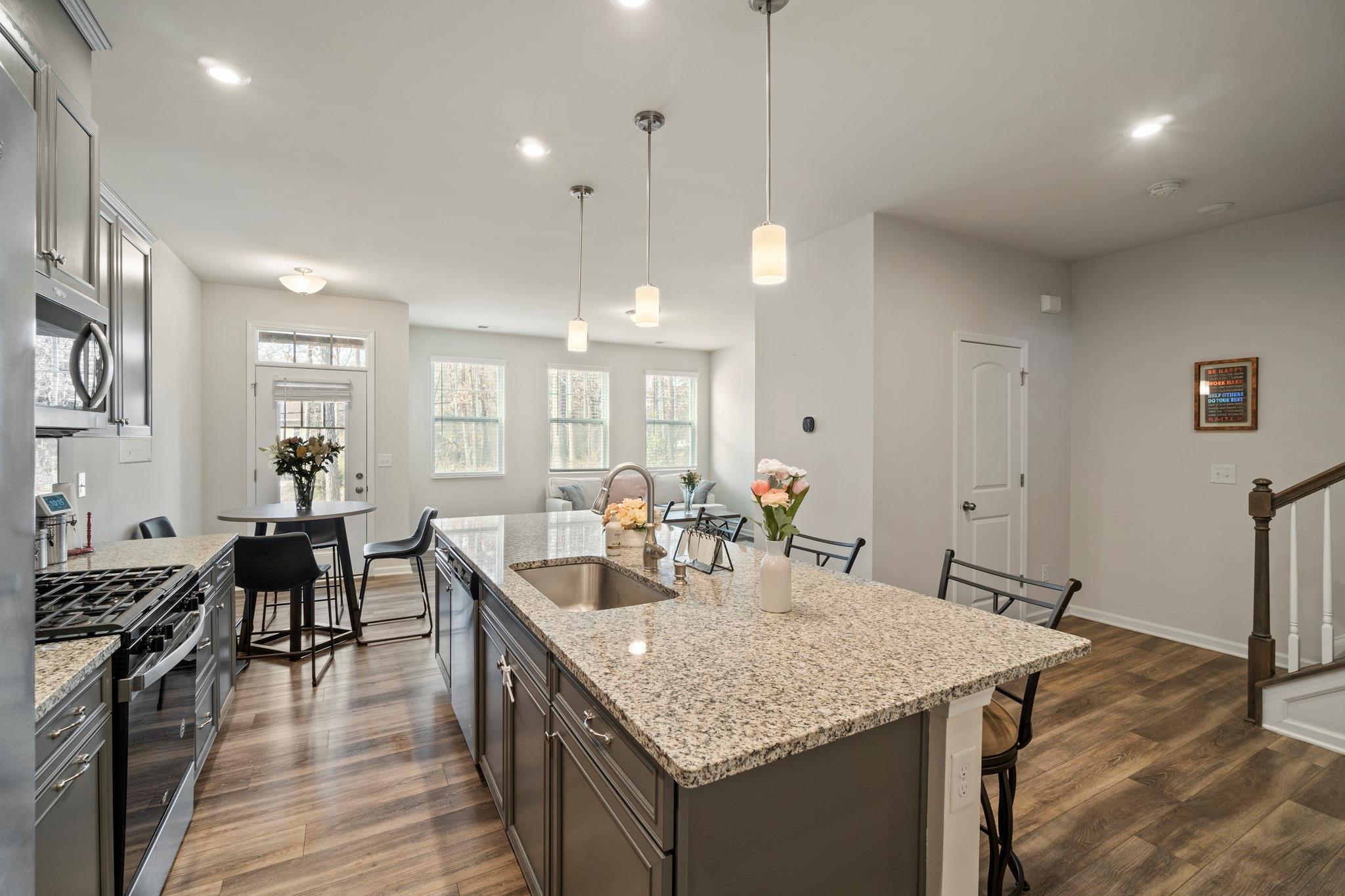 1564 Galloway Road Charlotte, NC 28262 - Photo 7 of 37 a kitchen with granite countertop kitchen island stainless steel appliances sink cabinets and wooden floor