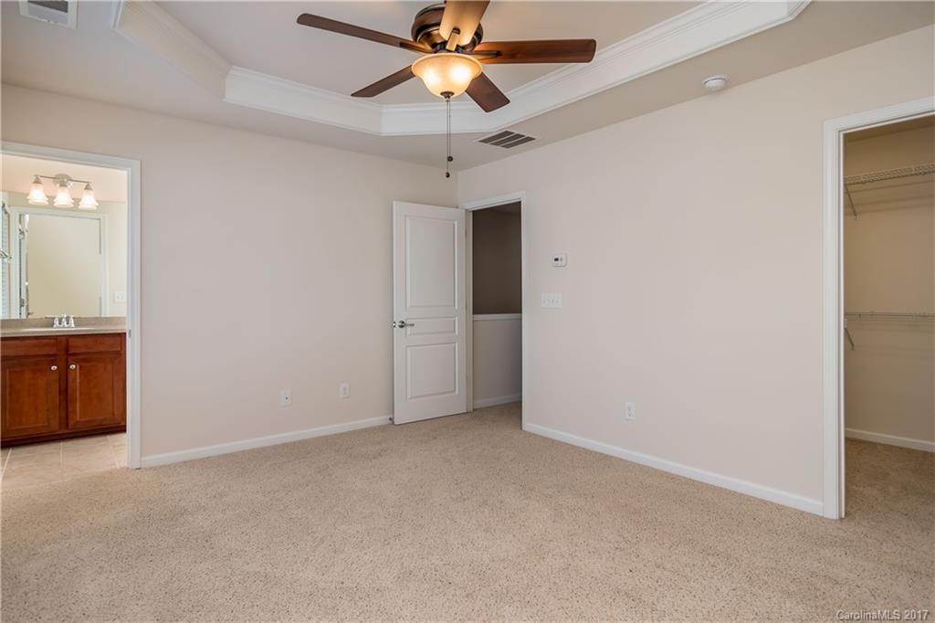 916 Lyndley Drive Fort Mill, SC 29708 - Photo 16 of 21 an empty room with closet and a chandelier fan