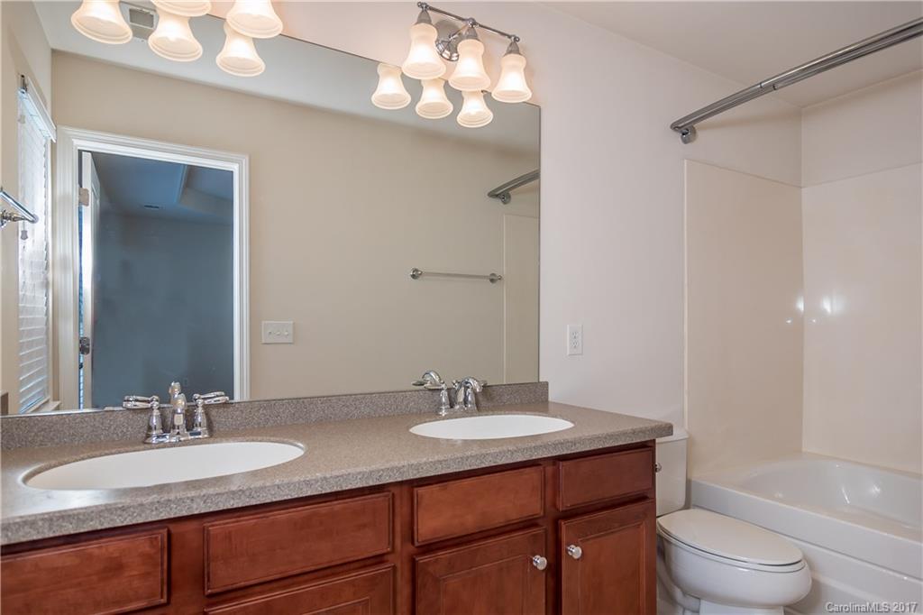 916 Lyndley Drive Fort Mill, SC 29708 - Photo 17 of 21 a bathroom with a granite countertop sink a toilet and a mirror