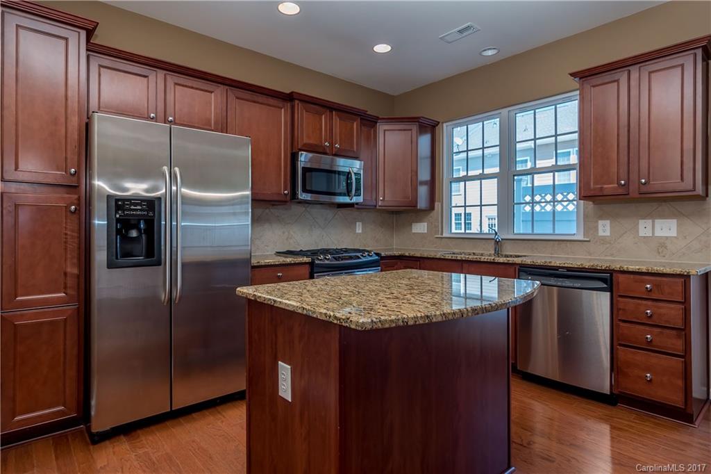 916 Lyndley Drive Fort Mill, SC 29708 - Photo 6 of 21 a kitchen with stainless steel appliances granite countertop a sink stove and refrigerator