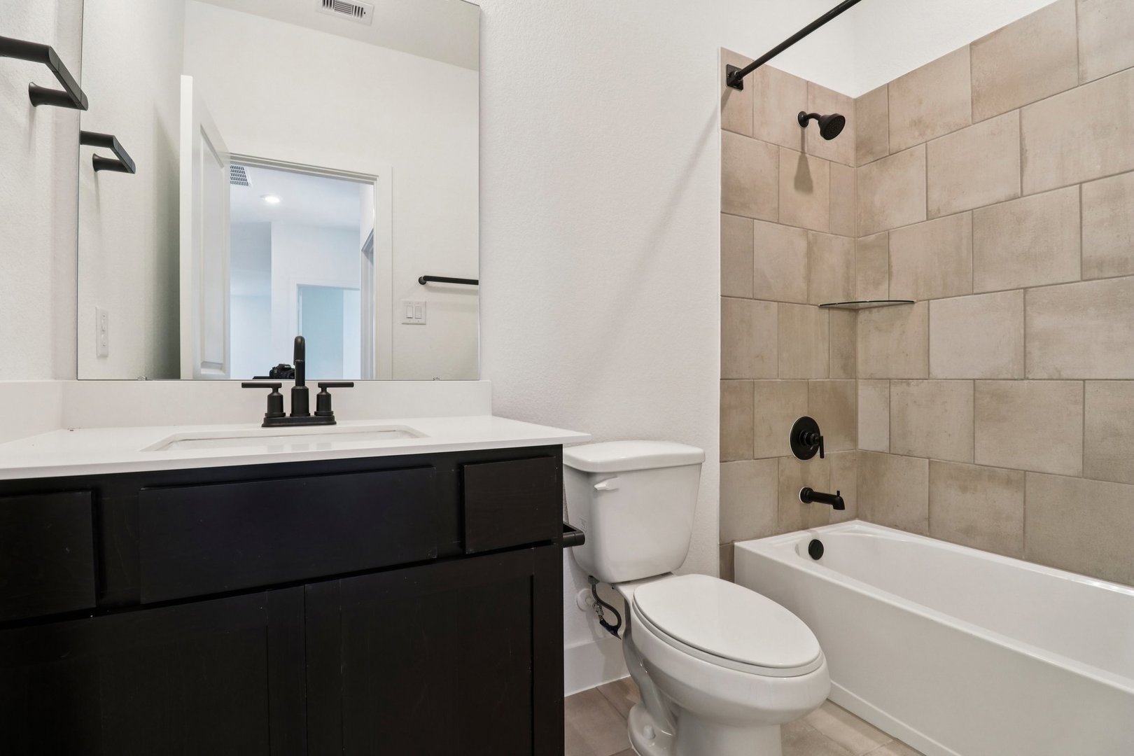14470 Trumpet Lane Splendora, TX 77372 - Photo 19 of 27 a bathroom with a sink toilet a mirror and shower