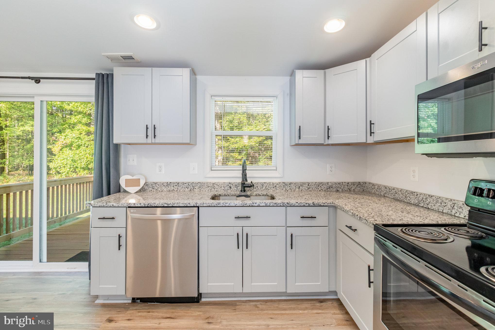 369 Circle Lane Colonial Beach, VA 22443 - Photo 4 of 18 a kitchen with cabinets appliances a sink and a window