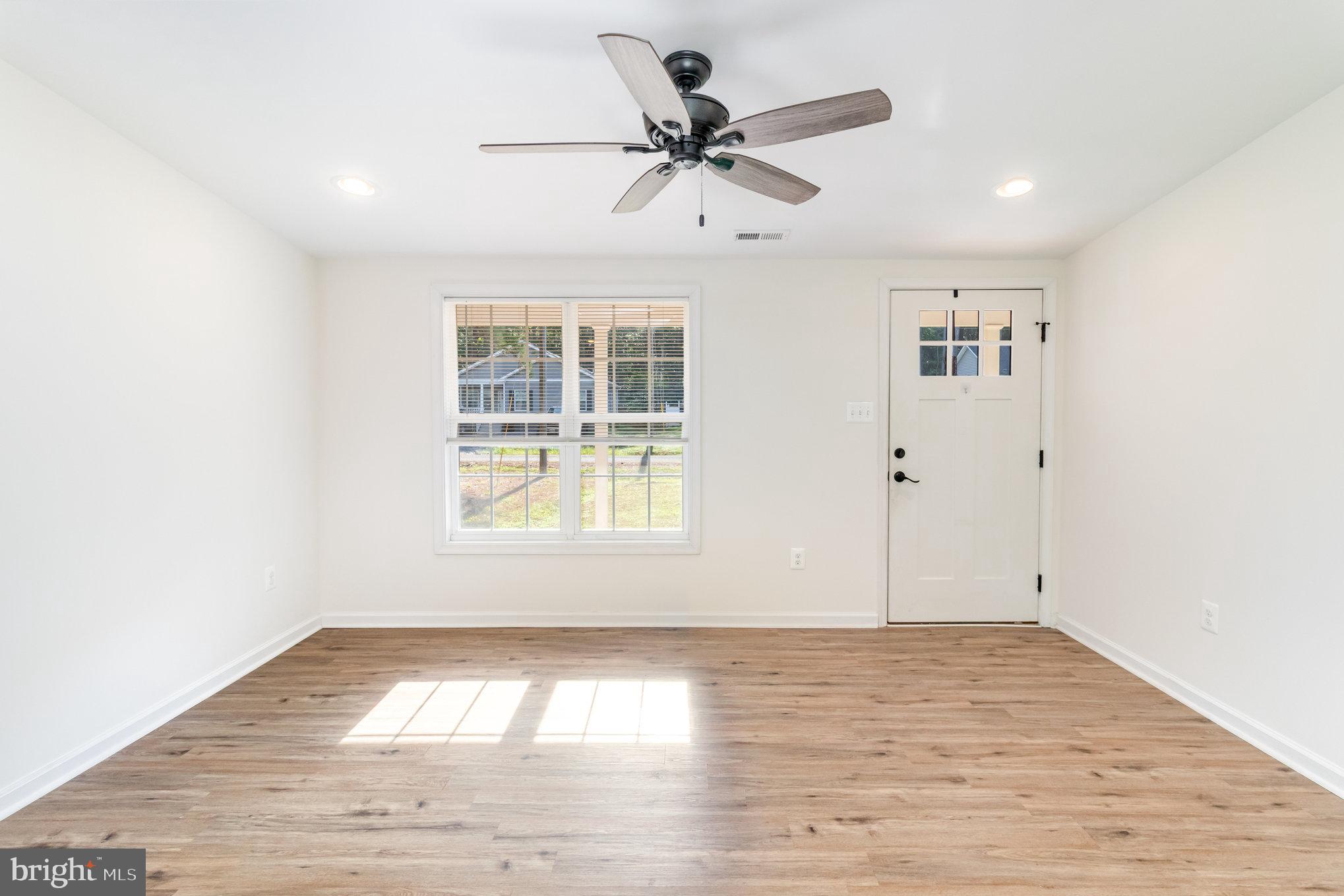 369 Circle Lane Colonial Beach, VA 22443 - Photo 5 of 18 an empty room with wooden floor and windows