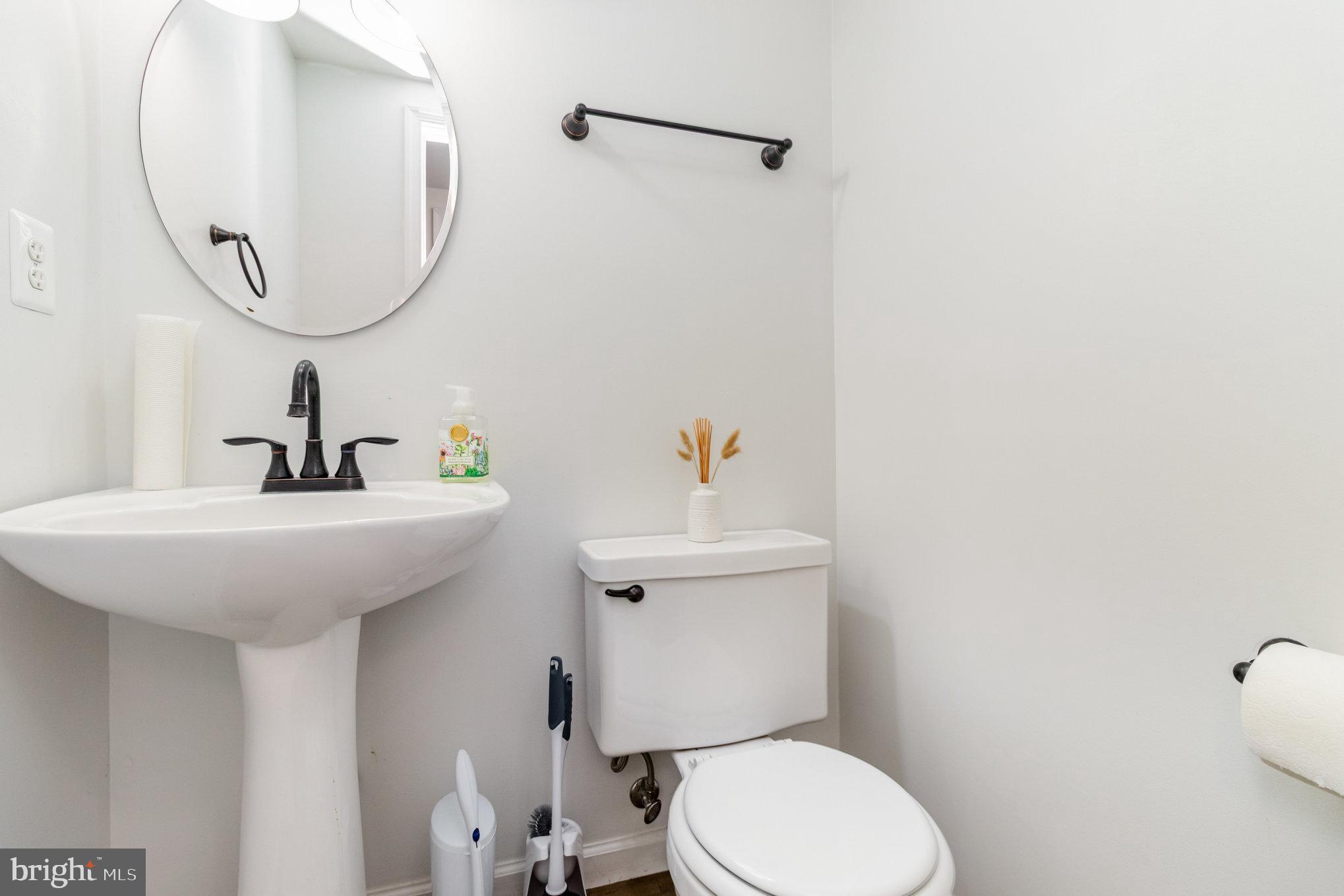 369 Circle Lane Colonial Beach, VA 22443 - Photo 6 of 18 a bathroom with a sink a mirror and a toilet