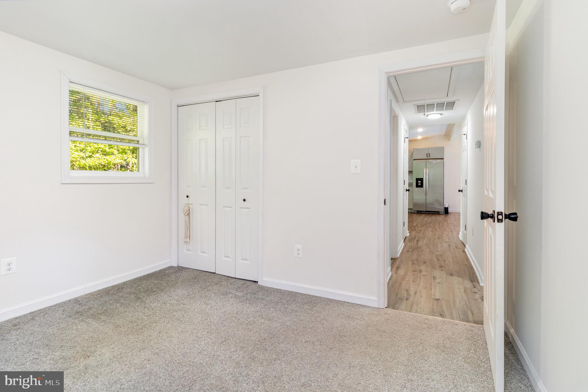 369 Circle Lane Colonial Beach, VA 22443 - Photo 8 of 18 a view of a hallway with wooden floor and a bathroom