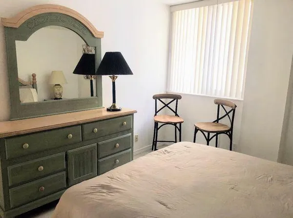 a bedroom with a bed and a chair