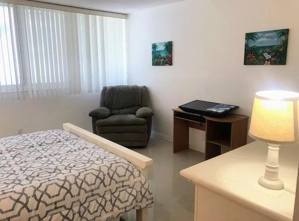 a bedroom with a bed and a couch