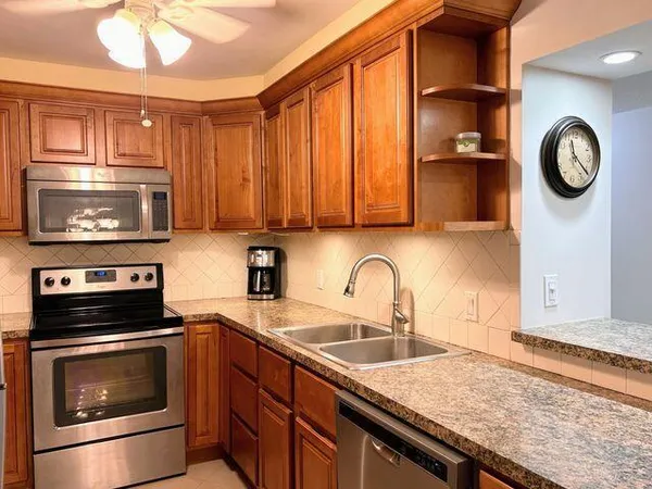 a kitchen with granite countertop a stove and a sink