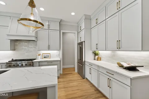 a bathroom with a sink a bathtub a mirror a vanity a window and vanity