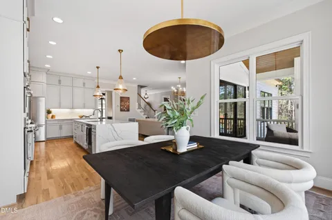 a view of a hallway with wooden floor and entryway