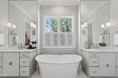 a bathroom with a glass shower door and mirror