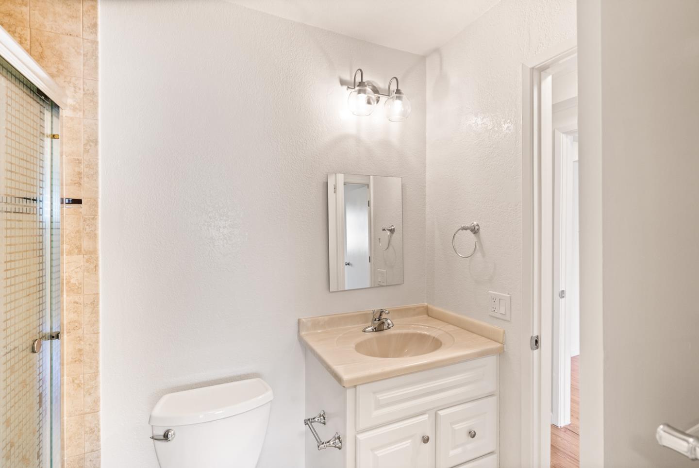 2419 Rowntree Way South San Francisco, CA 94080 - Photo 18 of 28 a bathroom with a sink a toilet a mirror and vanity