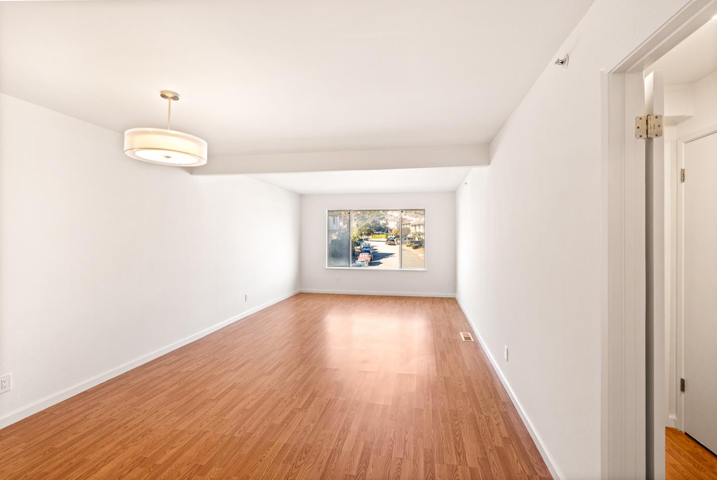 2419 Rowntree Way South San Francisco, CA 94080 - Photo 3 of 28 a view of a hallway with wooden floor and a chandelier